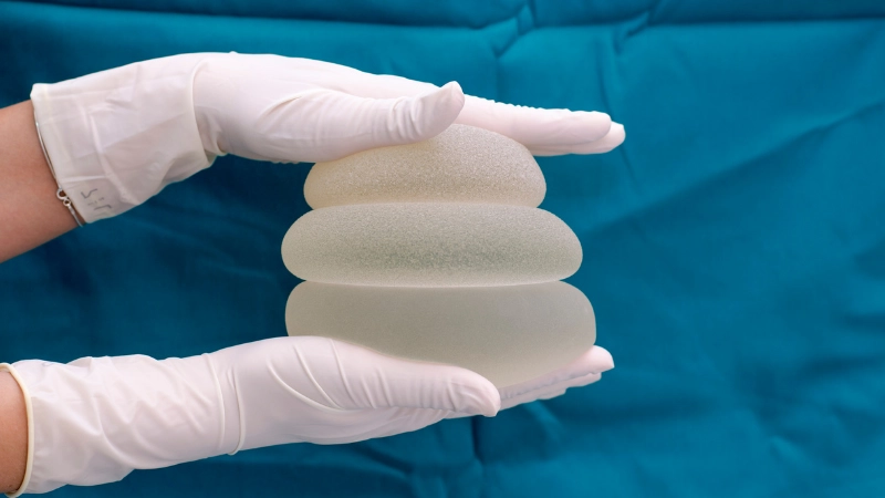 A man is pressing the silicone rubber to measure the damping properties