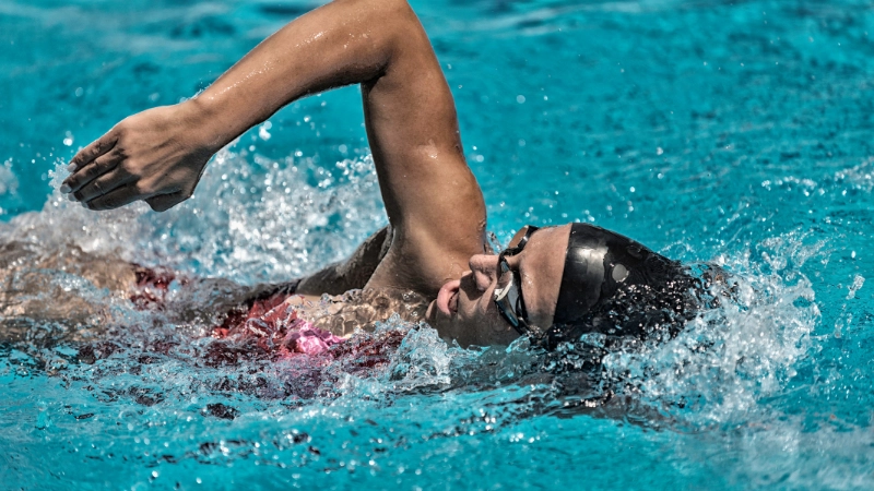 A woman wearing a swim cap