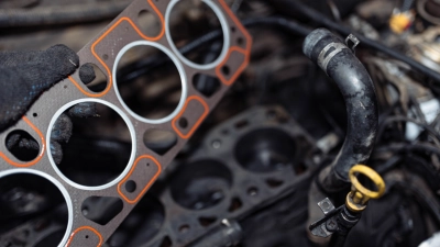 A man is putting a Viton gasket in the vehicle engine blocks