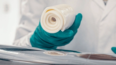 A roll of white silicone rubber sheet in a manufacturing or laboratory setting